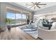 Bright living room with hardwood floors and sliding glass doors to a pool at 160 Stone Mesa Ct, Henderson, NV 89011