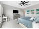 This is a beautifully staged main bedroom with light gray walls, nice decor, a ceiling fan, and a large window at 160 Stone Mesa Ct, Henderson, NV 89011