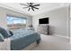 Beautiful main bedroom features neutral tones, ceiling fan, and a window with a view of the pool and mountains at 160 Stone Mesa Ct, Henderson, NV 89011
