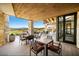 Covered patio area boasts stone columns, wood ceiling, sleek furniture and lovely views at 160 Stone Mesa Ct, Henderson, NV 89011