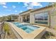 Backyard features a modern pool, spa, patio, and stunning desert landscape views at 160 Stone Mesa Ct, Henderson, NV 89011