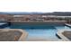 Sparkling pool with geometric design and lake views offers a refreshing outdoor experience at 160 Stone Mesa Ct, Henderson, NV 89011