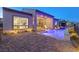 Outdoor living space with a modern pool, patio, and a view into the home's interior at 160 Stone Mesa Ct, Henderson, NV 89011