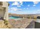 Inviting pool and spa with a brick patio overlooking the stunning desert landscape and mountains at 160 Stone Mesa Ct, Henderson, NV 89011