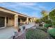 Charming backyard with a covered patio area and lush landscaping, creating a serene outdoor space at 1700 Wellington Springs Ave, Henderson, NV 89052