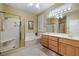 Bright bathroom featuring double sinks, a soaking tub, and a separate shower with gold trim at 1700 Wellington Springs Ave, Henderson, NV 89052