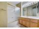 Bathroom featuring a bath tub with glass doors, vanity and cabinets at 1700 Wellington Springs Ave, Henderson, NV 89052