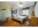 Comfortable bedroom with a ceiling fan, hardwood floors, and ample natural light at 1700 Wellington Springs Ave, Henderson, NV 89052