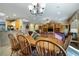 Bright dining area with a wooden table set, tile flooring, and seamless integration with the living space at 1700 Wellington Springs Ave, Henderson, NV 89052