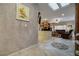 Open-concept foyer with a view into the living room, featuring tile floors and decorative wall finishes at 1700 Wellington Springs Ave, Henderson, NV 89052