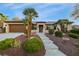 Charming single-story home featuring a desert landscape and inviting walkway to the front door at 1700 Wellington Springs Ave, Henderson, NV 89052