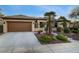 Single-story home with a neutral-toned exterior, complemented by a well-maintained front yard and spacious driveway at 1700 Wellington Springs Ave, Henderson, NV 89052