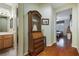Hallway with hardwood floors and decorative cabinet at 1700 Wellington Springs Ave, Henderson, NV 89052