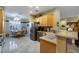 Well-lit kitchen with stainless steel appliances and tile floors opens to a dining area at 1700 Wellington Springs Ave, Henderson, NV 89052