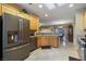 Spacious kitchen with stainless steel appliances and wood cabinets offering ample storage at 1700 Wellington Springs Ave, Henderson, NV 89052