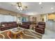 Inviting living room showcasing comfortable furniture, tile flooring, and a seamless transition to the dining space at 1700 Wellington Springs Ave, Henderson, NV 89052