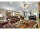 Open-concept living area with tile flooring, comfortable leather furniture, and a view of the dining area at 1700 Wellington Springs Ave, Henderson, NV 89052