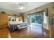 Spacious main bedroom featuring wood floors, a ceiling fan, and direct access to outdoor area at 1700 Wellington Springs Ave, Henderson, NV 89052