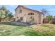 Backyard featuring stone paver patio with grill and seating, lawn area, and home in the background at 1800 Montvale Ct, Las Vegas, NV 89134