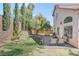 Charming backyard with stone pavers, seating, lawn and tall landscaping with the home in the background at 1800 Montvale Ct, Las Vegas, NV 89134