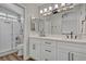 Bathroom with double sinks, modern lighting, and tiled shower at 1800 Montvale Ct, Las Vegas, NV 89134