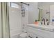 Bathroom with a tub/shower combo, white tile, and modern fixtures at 1800 Montvale Ct, Las Vegas, NV 89134