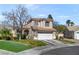 Two-story home with mature trees and a well-maintained lawn for enhanced curb appeal at 1800 Montvale Ct, Las Vegas, NV 89134