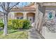 Home's entrance framed by lush greenery and tasteful architectural details at 1800 Montvale Ct, Las Vegas, NV 89134