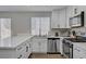 Bright kitchen featuring white cabinets, stainless steel appliances, and quartz countertops at 1800 Montvale Ct, Las Vegas, NV 89134