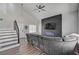 Comfortable living room with gray sectional sofa, fireplace, and staircase at 1800 Montvale Ct, Las Vegas, NV 89134