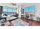 Bright bedroom with large windows offering scenic city views, a bed, and a desk at 200 W Sahara Ave # 801, Las Vegas, NV 89102