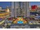 Luxury high-rise building featuring a pool with city views and a landscaped lounge area at dusk at 200 W Sahara Ave # 801, Las Vegas, NV 89102
