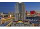 Luxury high-rise featuring a rooftop pool and city views at dusk at 200 W Sahara Ave # 801, Las Vegas, NV 89102