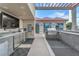 Gourmet outdoor kitchen area with stainless steel appliances, grill and seating area at 200 W Sahara Ave # 801, Las Vegas, NV 89102