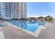 Community pool with comfortable lounge chairs and clear blue water at 200 W Sahara Ave # 801, Las Vegas, NV 89102