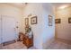 Welcoming foyer with neutral tile flooring, a charming console table, and tasteful decor providing a warm entrance at 2136 Eagle Sticks Dr, Henderson, NV 89012