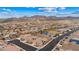 An aerial view captures the home in its desert community, backed by majestic mountains at 2150 Grant Union Ct, Laughlin, NV 89029