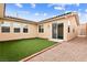 Low-maintenance backyard featuring artificial grass and access to the house at 2150 Grant Union Ct, Laughlin, NV 89029