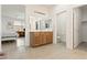 Bright bathroom boasts a vanity with cabinets, large mirror, and access to bedroom and walk-in closet at 2150 Grant Union Ct, Laughlin, NV 89029
