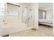 This bathroom features a soaking tub, glass-enclosed shower, large window, and access to the bedroom at 2150 Grant Union Ct, Laughlin, NV 89029
