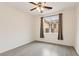 This bright, airy bedroom offers a ceiling fan and view of the fenced backyard through a large window at 2150 Grant Union Ct, Laughlin, NV 89029
