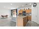 Modern kitchen with stainless appliances, stone countertops, an island, and open dining space at 2150 Grant Union Ct, Laughlin, NV 89029
