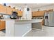 Bright kitchen featuring a breakfast bar, stainless steel refrigerator, and wood cabinets at 2150 Grant Union Ct, Laughlin, NV 89029