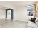 Open living area with neutral tile flooring, a comfortable couch, and bright window views at 2150 Grant Union Ct, Laughlin, NV 89029