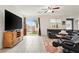 Comfortable living room with large TV, ceiling fan, leather seating, and backyard access at 2150 Grant Union Ct, Laughlin, NV 89029