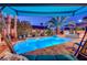 Beautiful backyard pool with covered seating area and lush tropical landscaping at 2264 Pacini Ct, Henderson, NV 89052