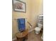 Cozy powder room features tile flooring, grab bar, and comfort height toilet at 2300 S Washoe Ave, Pahrump, NV 89048