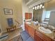 Bathroom features a double sink vanity with granite countertops and wood cabinets at 2300 S Washoe Ave, Pahrump, NV 89048