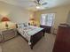 Bright bedroom featuring a ceiling fan, dresser, and floral bedding at 2300 S Washoe Ave, Pahrump, NV 89048