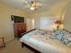 Bedroom boasts a ceiling fan, closet, and a floral bed at 2300 S Washoe Ave, Pahrump, NV 89048